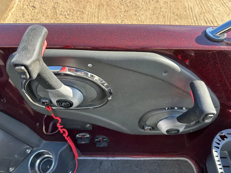 Slide: The Image of 2012 Ranger 619VS boat controls with dual levers and red safety cord. - 7