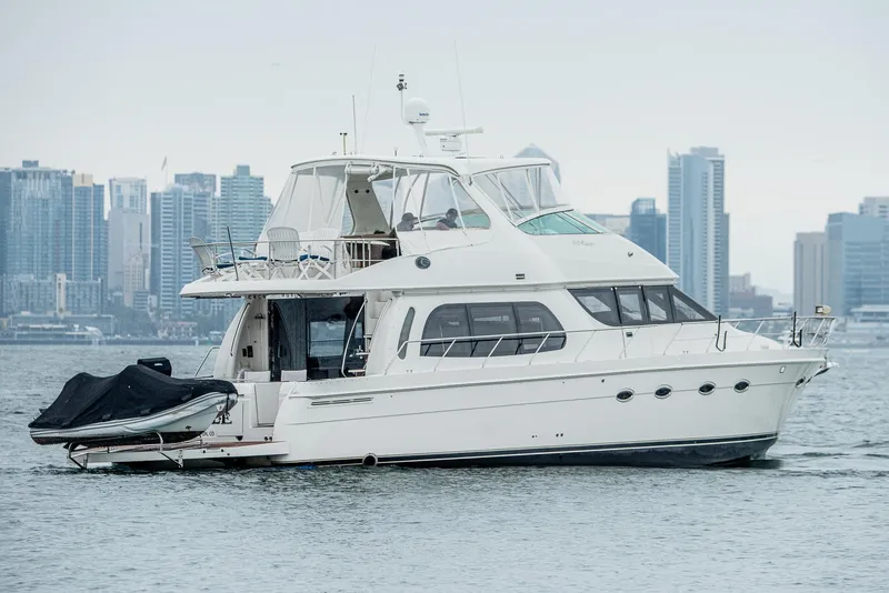 Slide: The Image of 2005 Carver 560 Voyager yacht cruising near city skyline. - 2