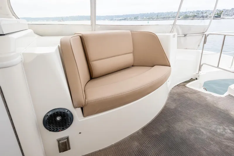 Slide: The Image of 2005 Carver 560 Voyager boat interior with tan seating and lake view. - 24