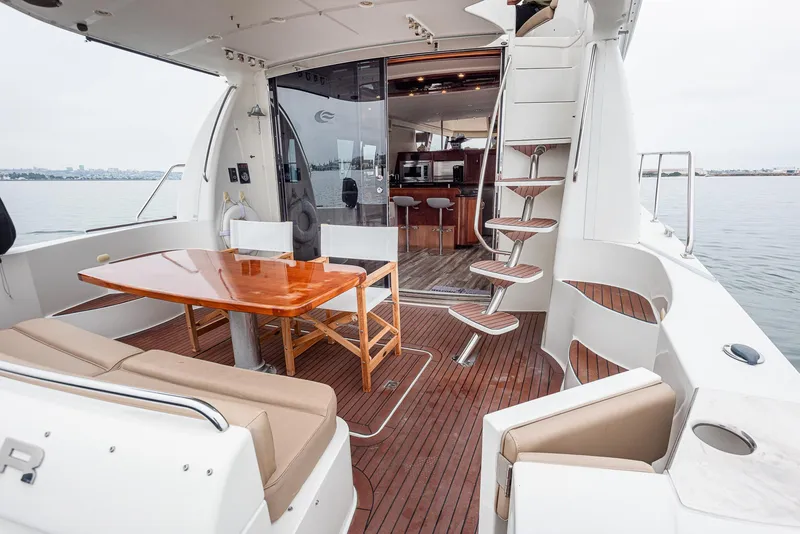 Slide: The Image of 2005 Carver 560 Voyager yacht interior with elegant seating and wooden table. - 27