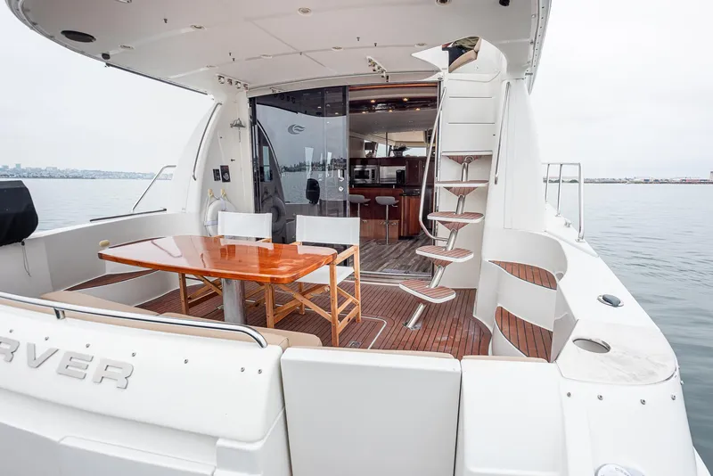 Slide: The Image of 2005 Carver 560 Voyager yacht with outdoor dining area and spiral staircase. - 28