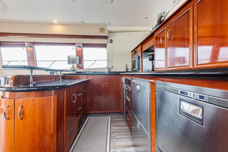 Slide: The Image of Luxurious kitchen interior of 2005 Carver 560 Voyager yacht with wood cabinetry and stainless appliances. - 31