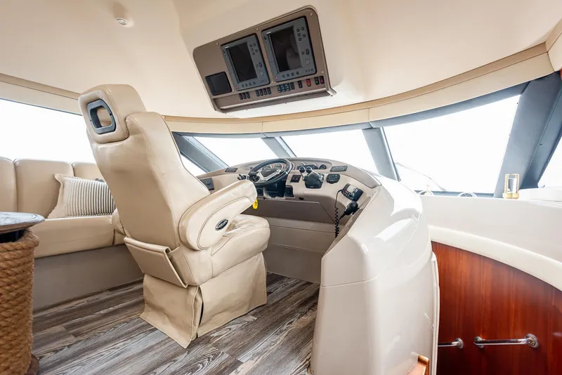 Slide: The Image of Luxurious helm of 2005 Carver 560 Voyager yacht with leather seating and modern controls. - 35