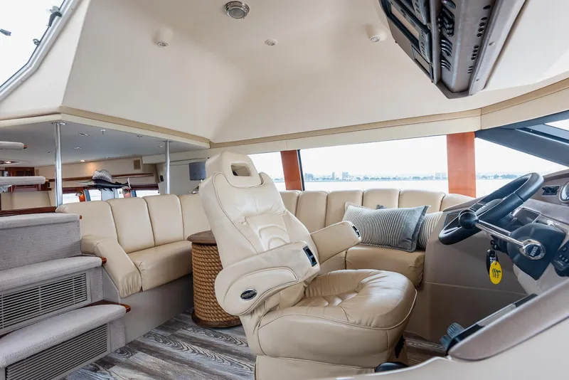Slide: The Image of Luxurious interior of 2005 Carver 560 Voyager yacht with plush seating and modern helm. - 38
