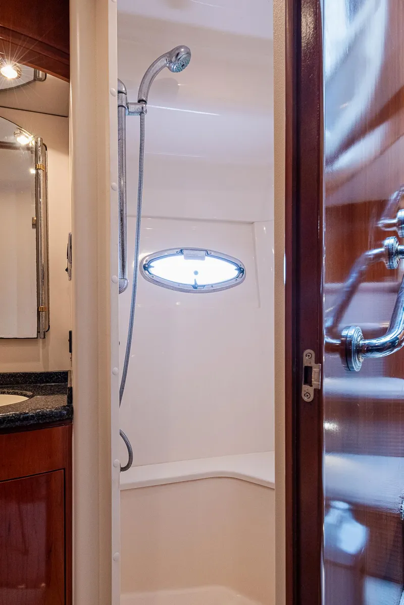 Slide: The Image of 2005 Carver 560 Voyager yacht bathroom with shower and porthole window. - 46