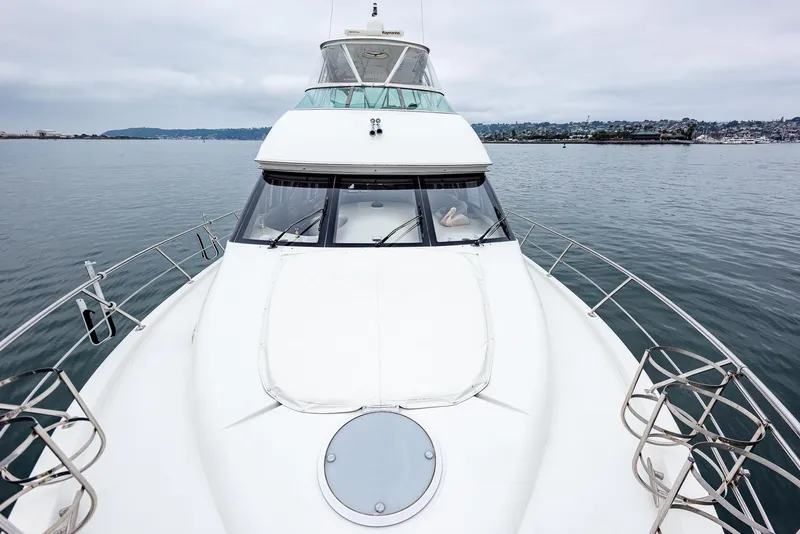 Slide: The Image of 2005 Carver 560 Voyager yacht on calm water, front view. - 7