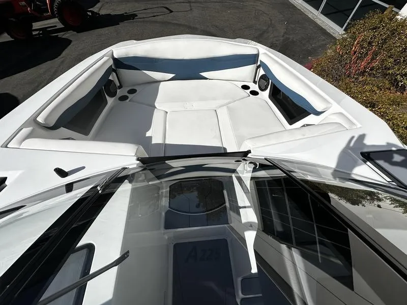 Slide: The Image of 2025 Axis A225 boat interior with white seating and cup holders. - 7
