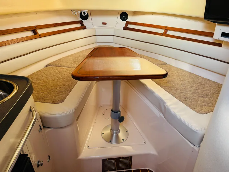 Slide: The Image of 2005 Grady-White Marlin 300 cabin interior with table and seating. - 11