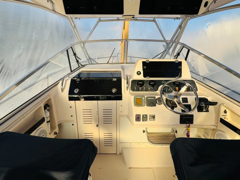 Slide: The Image of 2005 Grady-White Marlin 300 boat cockpit with steering wheel and control panel. - 3