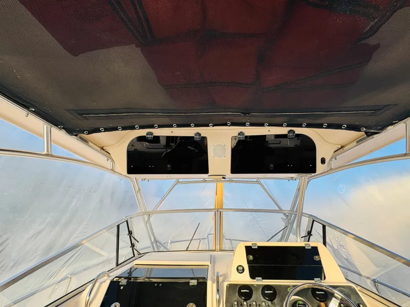 Slide: The Image of 2005 Grady-White Marlin 300 boat cockpit with steering wheel and dashboard. - 4