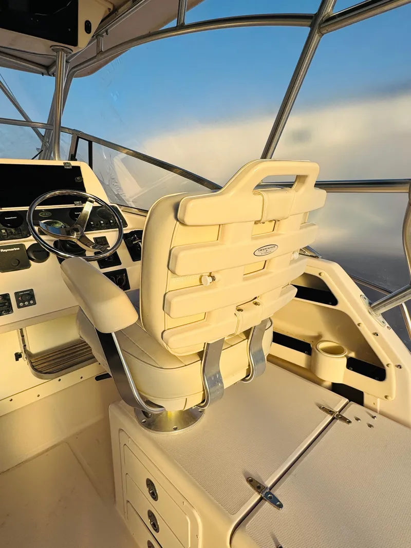 Slide: The Image of 2005 Grady-White Marlin 300 helm with beige captain's chair and steering wheel. - 9