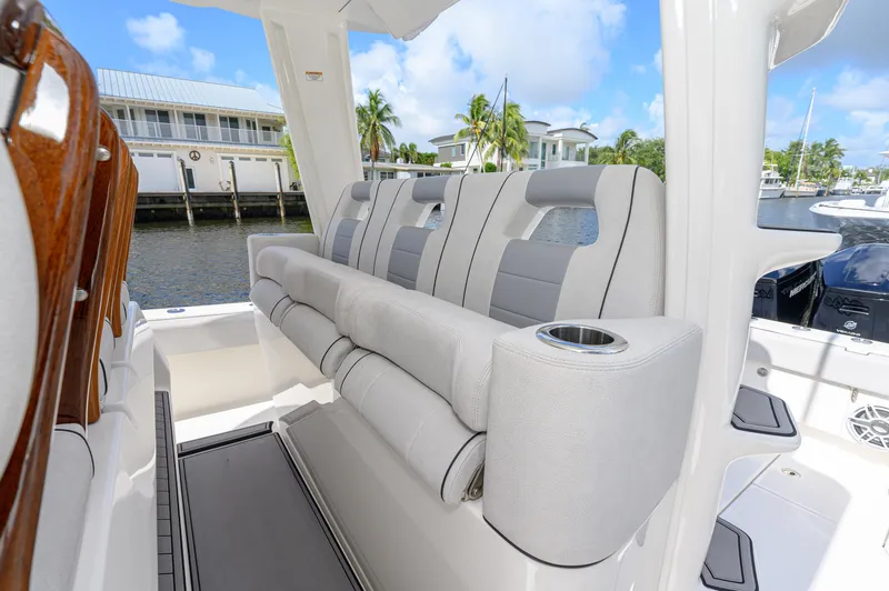 Slide: The Image of 2023 SeaVee 420Z boat interior with plush seating and cup holders. - 10