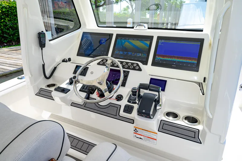 Slide: The Image of 2023 SeaVee 420Z helm with advanced navigation displays and controls. - 13