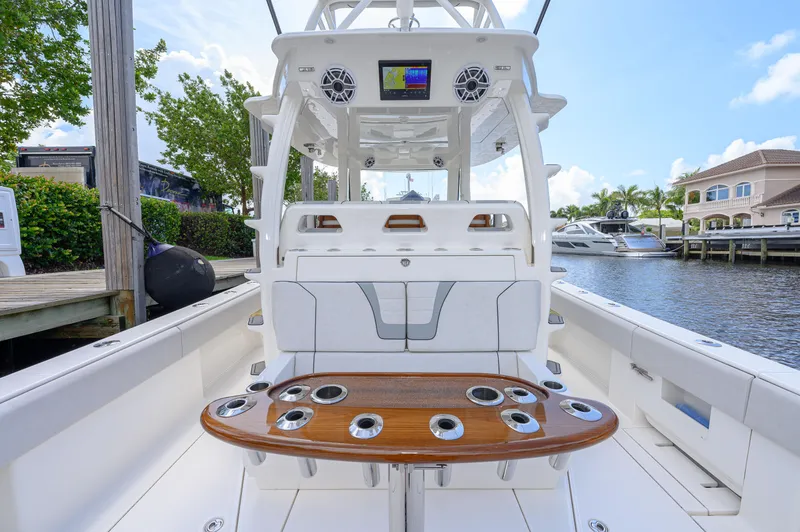 Slide: The Image of 2023 SeaVee 420Z boat with sleek design, spacious deck, and modern amenities at a marina. - 21