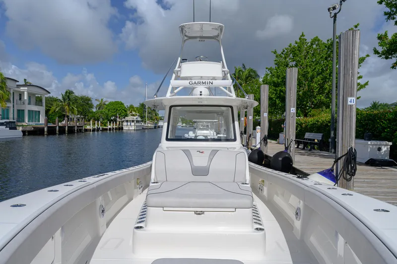 Slide: The Image of 2023 SeaVee 420Z boat docked by a scenic waterfront. - 23