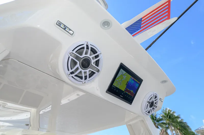 Slide: The Image of 2023 SeaVee 420Z boat with speakers and navigation screen, American flag, palm trees, blue sky. - 24