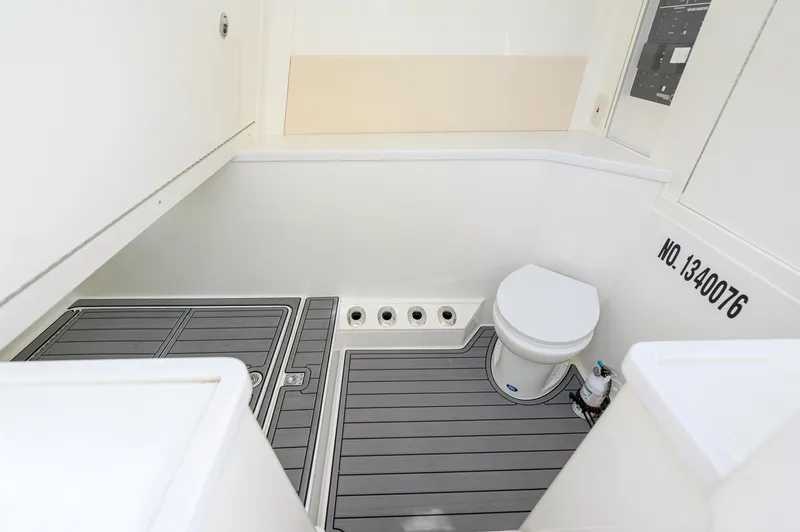 Slide: The Image of Interior of 2023 SeaVee 420Z boat bathroom with modern fixtures and gray flooring. - 25