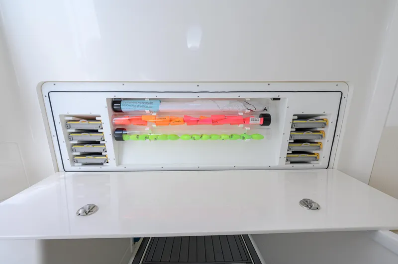 Slide: The Image of Fishing tackle storage on 2023 SeaVee 420Z boat, featuring organized lures and equipment. - 26