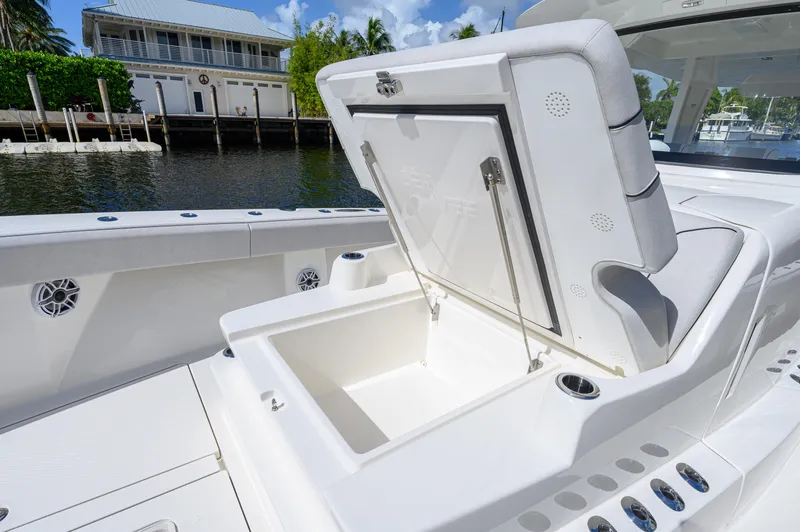 Slide: The Image of 2023 SeaVee 420Z boat with open storage compartment, dockside view. - 28