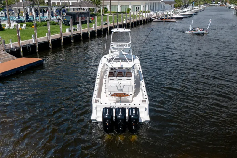 Slide: The Image of 2023 SeaVee 420Z boat with four engines on a calm waterway. - 5