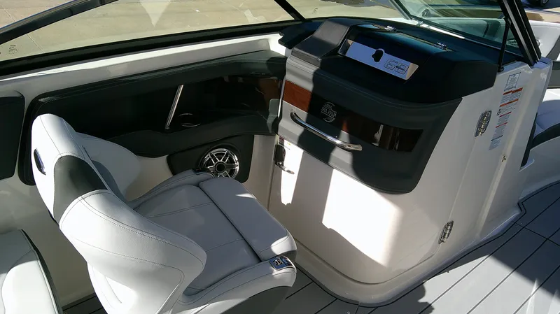 Slide: The Image of 2025 Chaparral 28 Surf boat interior with sleek seating and modern dashboard. - 10
