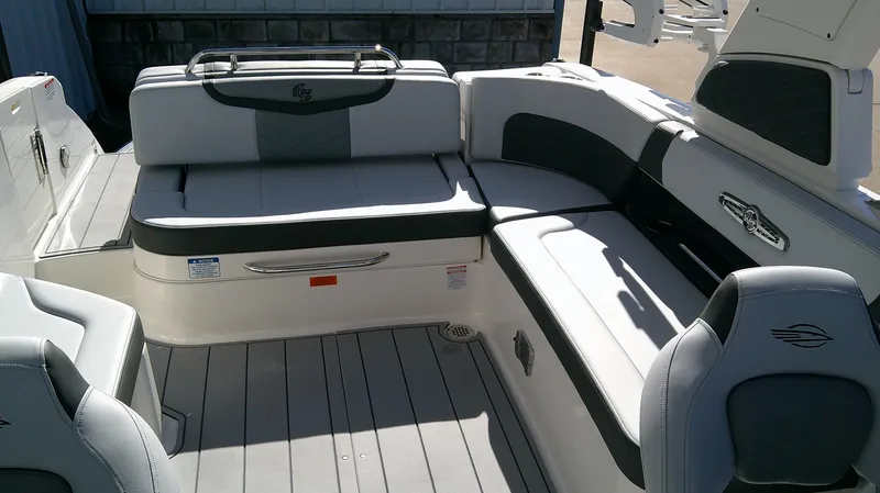 Slide: The Image of 2025 Chaparral 28 Surf boat interior with cushioned seating and sleek design. - 6