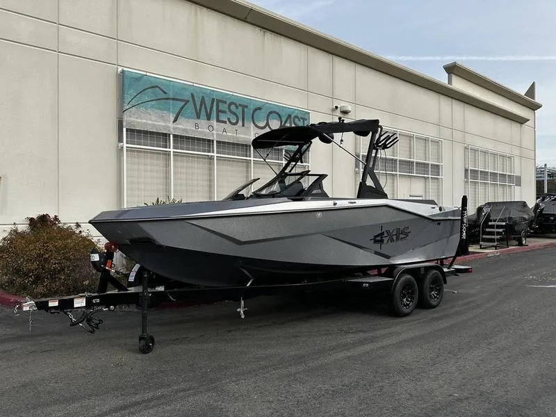 The Image of 2025 Axis T220 boat on trailer outside West Coast Boats building. - 0