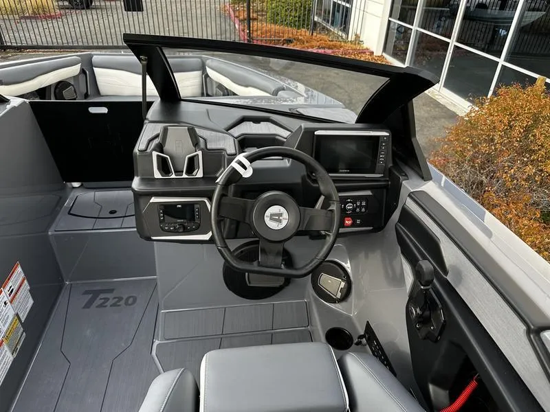 Slide: The Image of 2025 Axis T220 boat interior with modern dashboard and steering wheel. - 5