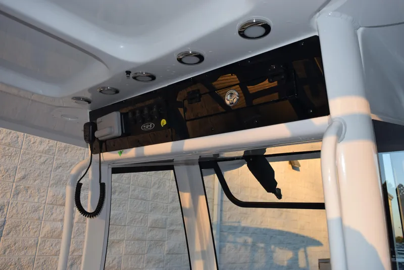 Slide: The Image of 2025 Sea Hunt Gamefish 28 boat console with radio and controls. - 10