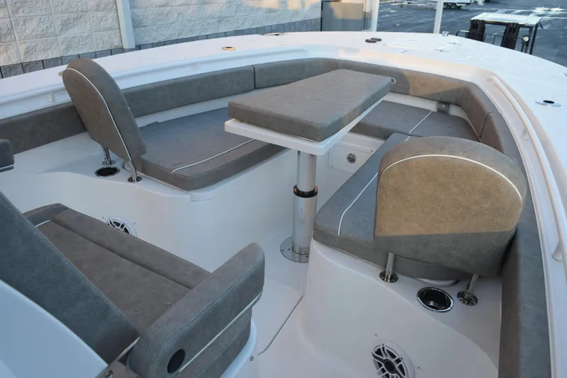 Slide: The Image of 2025 Sea Hunt Gamefish 28 boat interior with cushioned seating and table. - 12