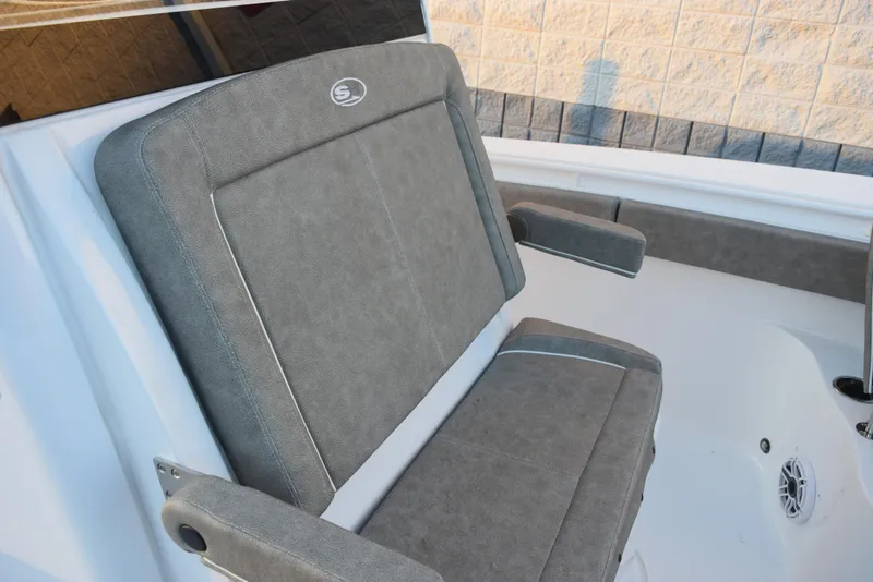 Slide: The Image of 2025 Sea Hunt Gamefish 28 boat seat with gray upholstery and armrests. - 13
