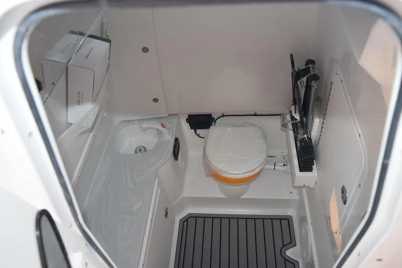Slide: The Image of 2025 Sea Hunt Gamefish 28 boat interior with compact bathroom amenities. - 15