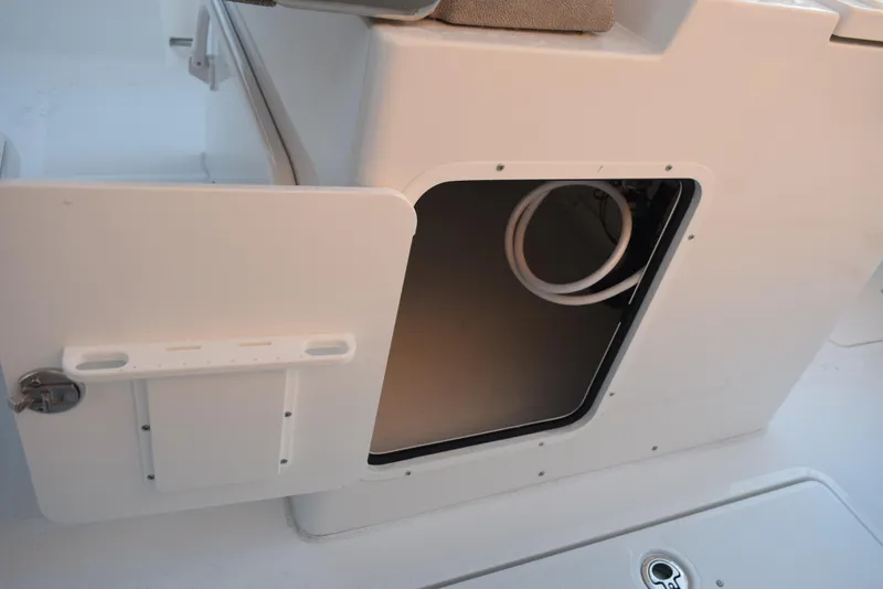 Slide: The Image of 2025 Sea Hunt Gamefish 28 storage compartment with open hatch, showcasing interior space. - 18