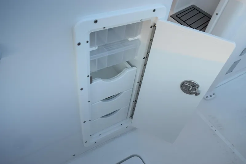 Slide: The Image of Storage compartment on 2025 Sea Hunt Gamefish 28 boat, featuring organized interior drawers. - 22