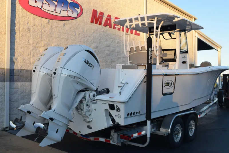 Slide: The Image of 2025 Sea Hunt Gamefish 28 boat with dual Yamaha engines on a trailer. - 3
