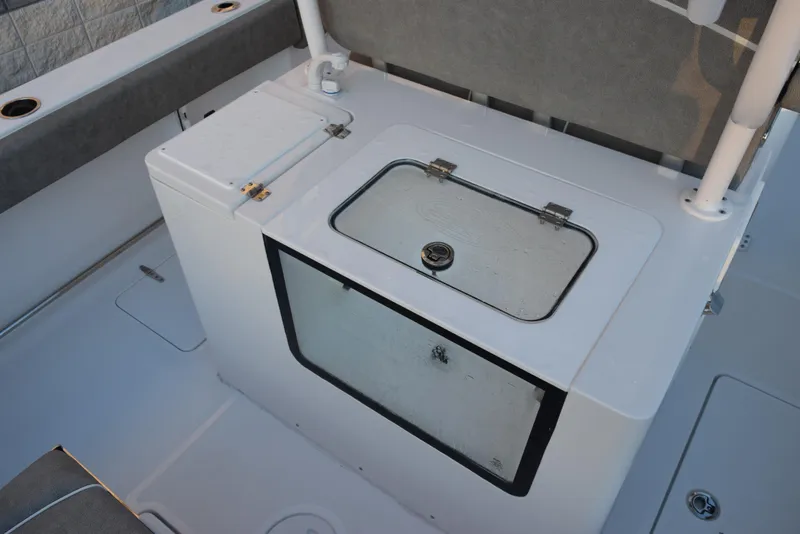 Slide: The Image of 2025 Sea Hunt Gamefish 28 boat interior with livewell and storage compartment. - 7