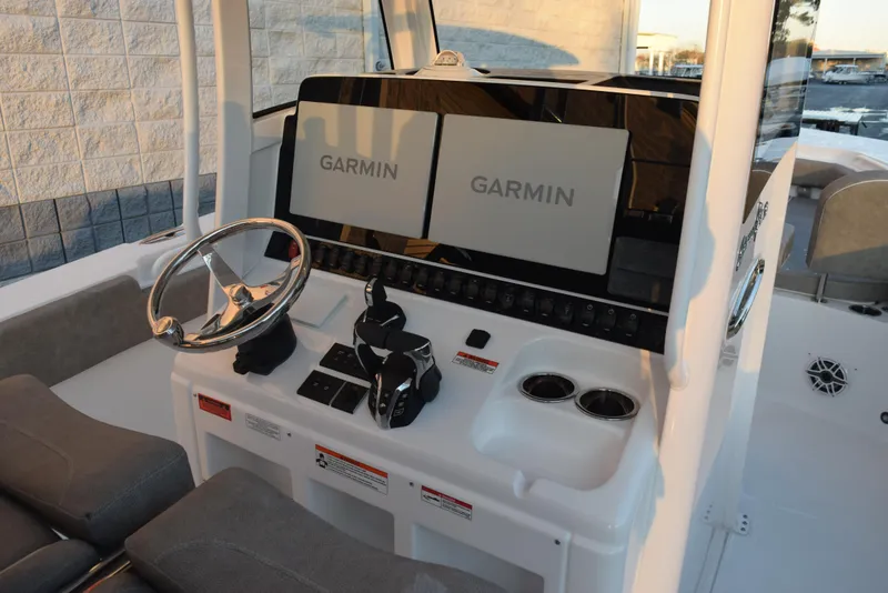 Slide: The Image of 2025 Sea Hunt Gamefish 28 boat dashboard with dual Garmin displays and steering wheel. - 9