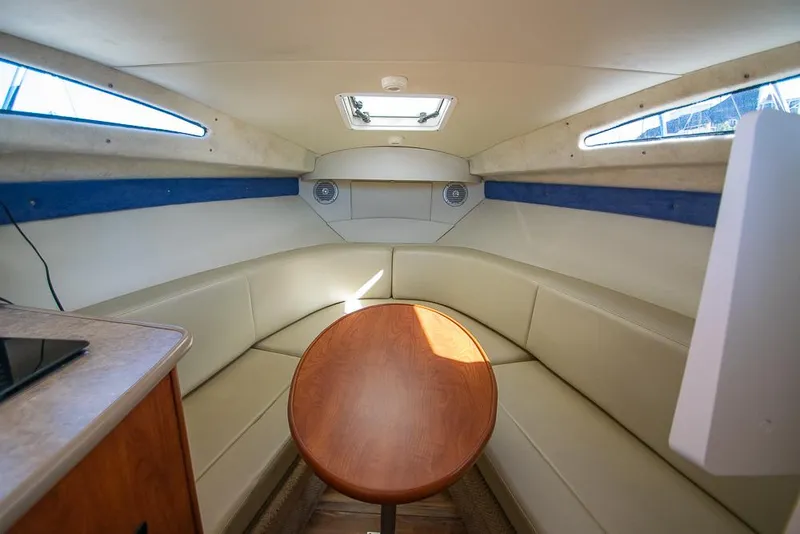 Slide: The Image of Interior of 2010 Bayliner 2450 Ciera boat with seating and table. - 10
