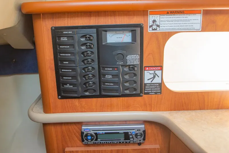 Slide: The Image of Control panel and stereo system in 2010 Bayliner 2450 Ciera boat interior. - 17