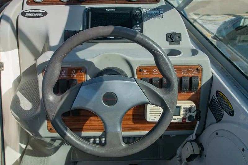 Slide: The Image of Steering wheel and dashboard of 2010 Bayliner 2450 Ciera boat. - 25