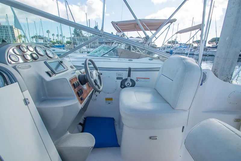 Slide: The Image of 2010 Bayliner 2450 Ciera boat cockpit with steering wheel and control panel, docked at marina. - 27