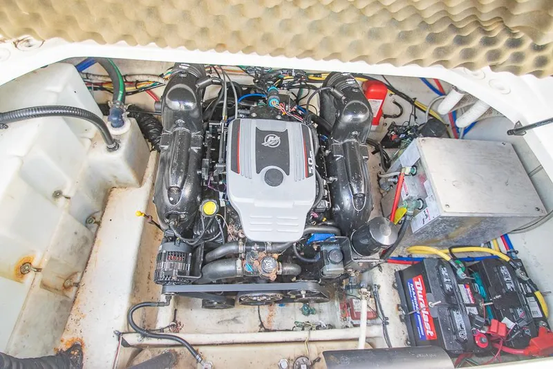 Slide: The Image of Engine compartment of a 2010 Bayliner 2450 Ciera boat, featuring a well-maintained motor. - 30