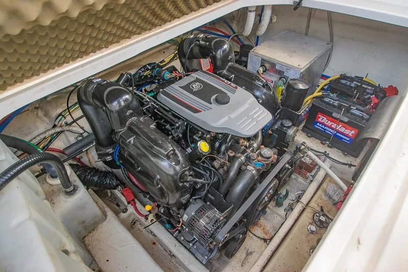 Slide: The Image of Engine compartment of a 2010 Bayliner 2450 Ciera boat, featuring a well-maintained motor. - 31