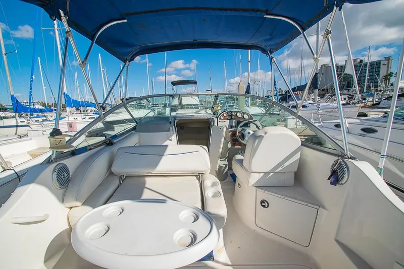 Slide: The Image of 2010 Bayliner 2450 Ciera boat interior with seating and steering, docked at marina. - 5