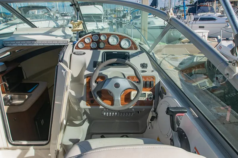 Slide: The Image of 2010 Bayliner 2450 Ciera boat cockpit with steering wheel and instrument panel. - 8