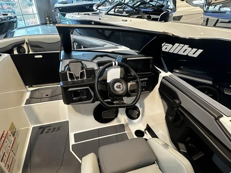 Slide: The Image of 2025 Axis T235 boat interior with modern steering and dashboard design. - 4