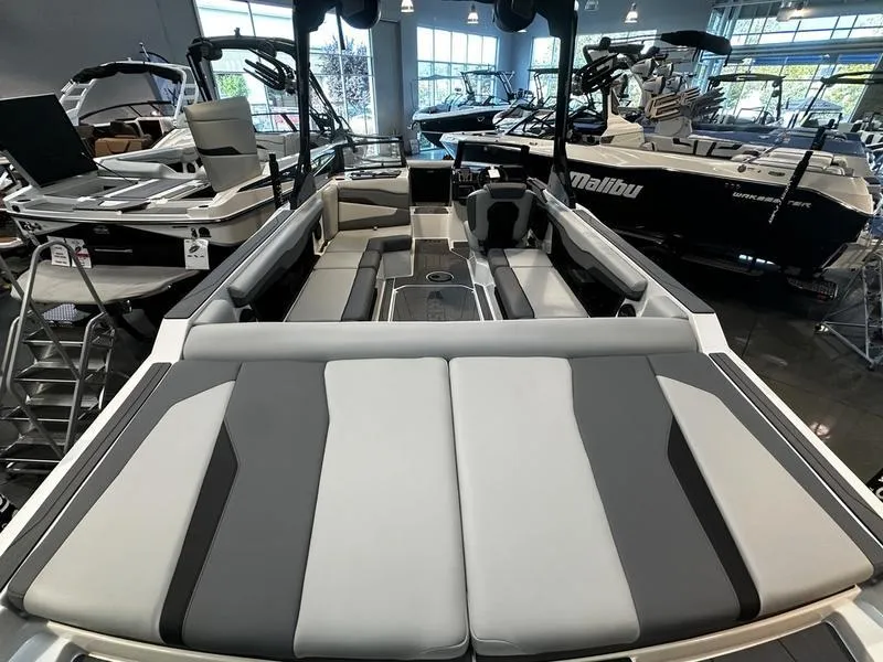 Slide: The Image of 2025 Axis T235 boat interior with sleek seating in a showroom. - 7