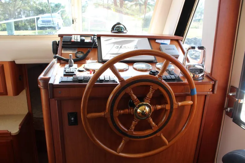 Slide: The Image of Helm of 2008 Mainship 34 Trawler Hardtop with wooden steering wheel and navigation instruments. - 10