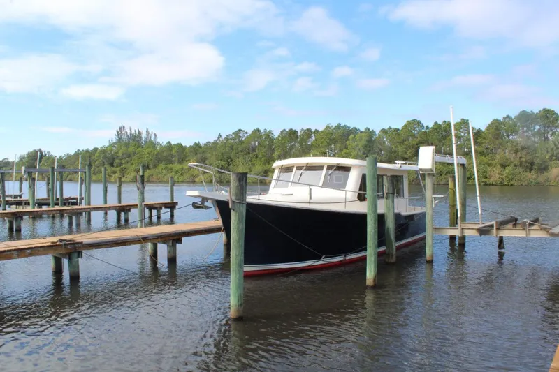 Slide: The Image of 2008 Mainship 34 Trawler Hardtop docked on a calm river. - 30