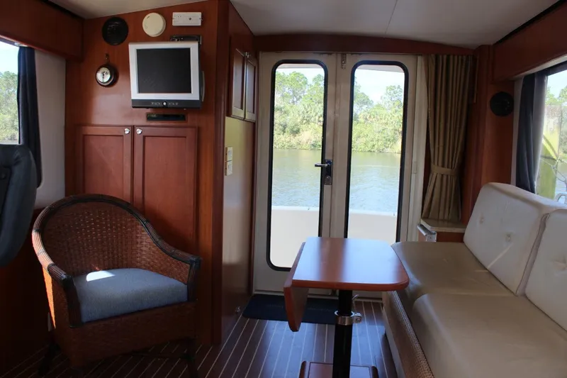 Slide: The Image of Interior of 2008 Mainship 34 Trawler Hardtop with seating, table, and TV. - 9